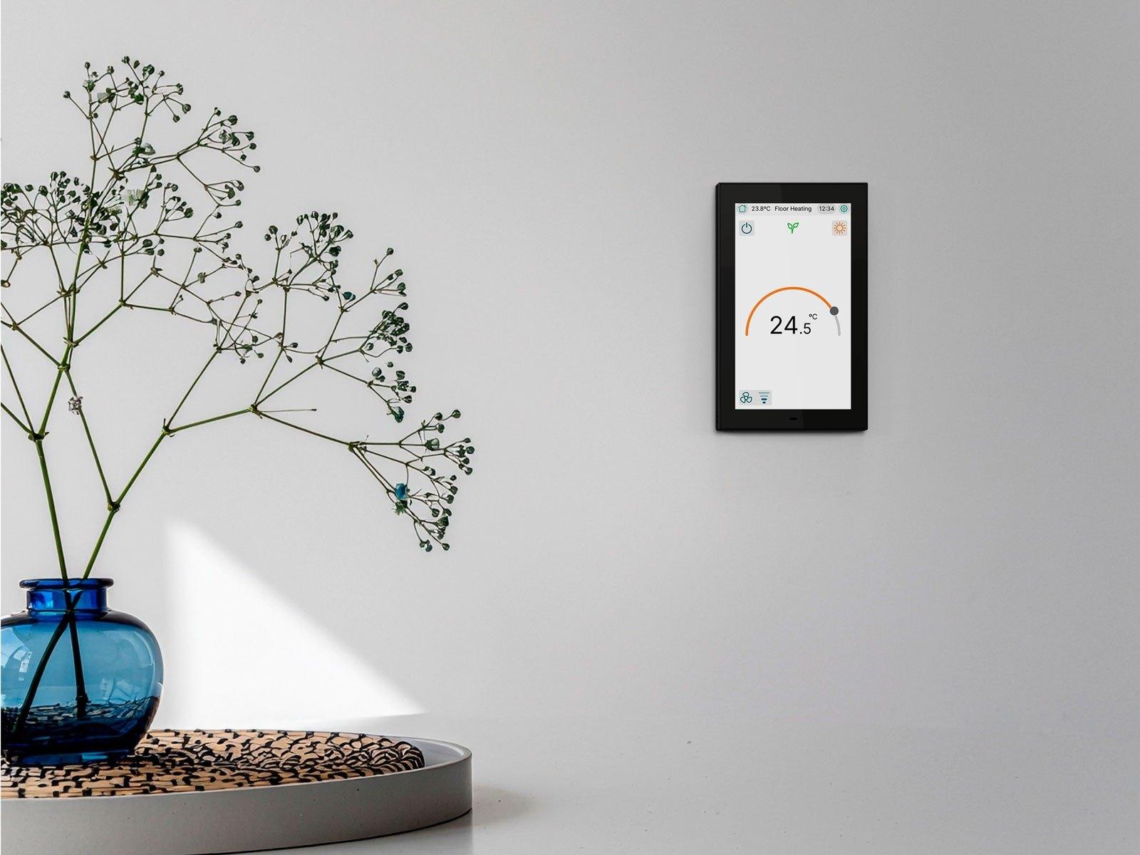 Zennio KNX touch panel beside a vase of flowers